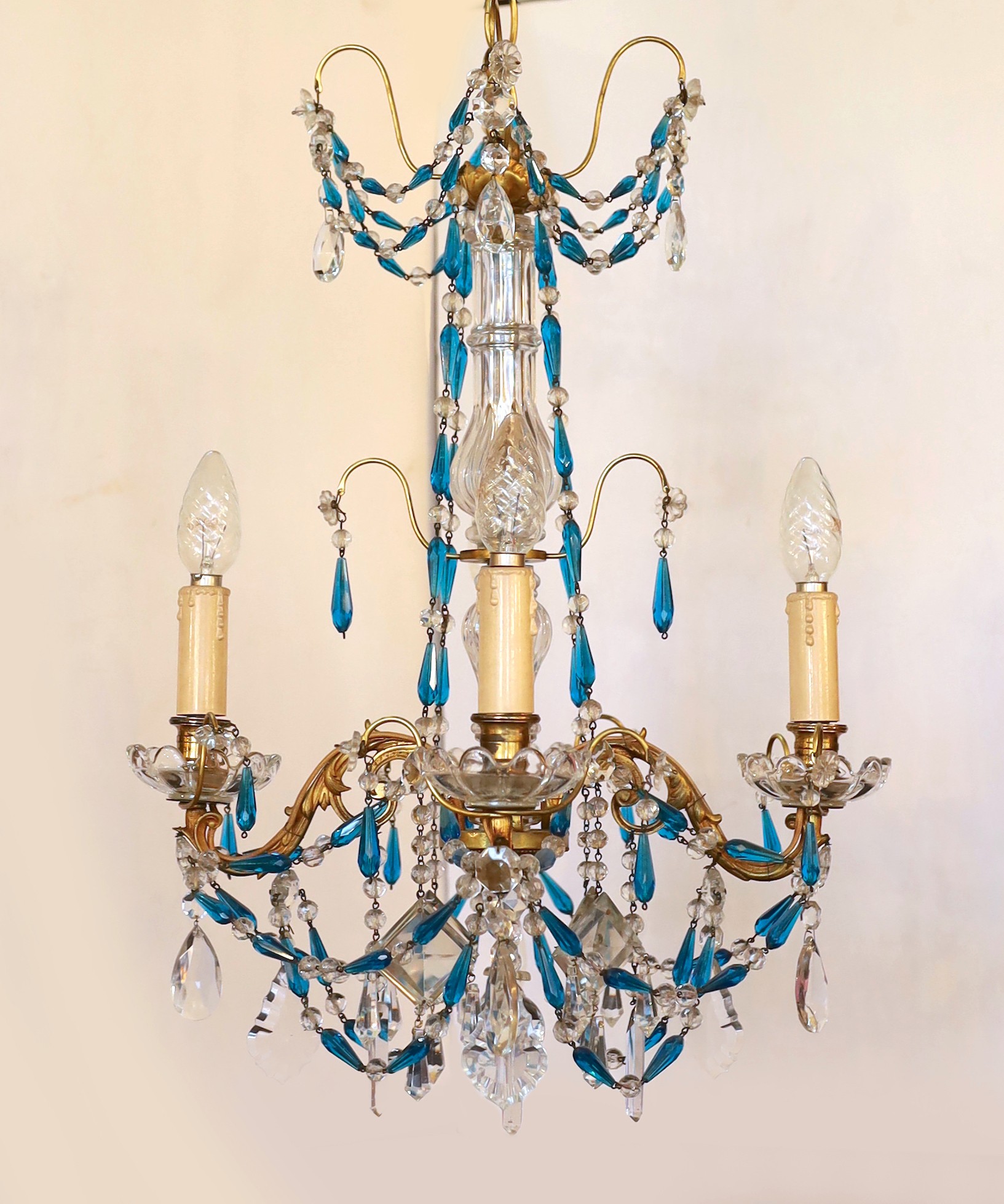 An early 20th century French gilt brass clear and blue glass four light chandelier, drop 80cm. width 40cm